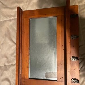Shelf mirror, with hanging hooks.